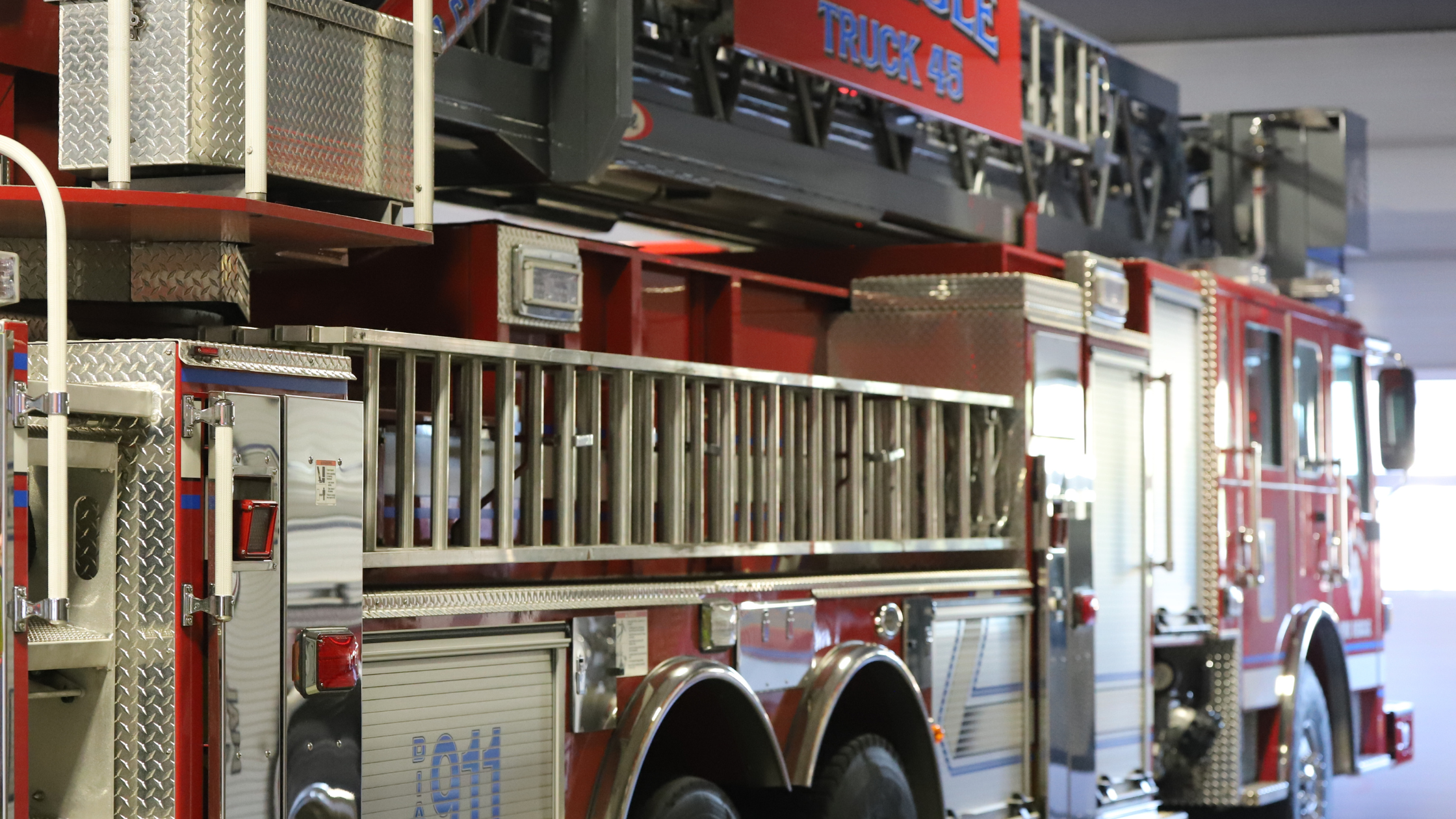 A detailed photo of a firetruck parked in a fire station