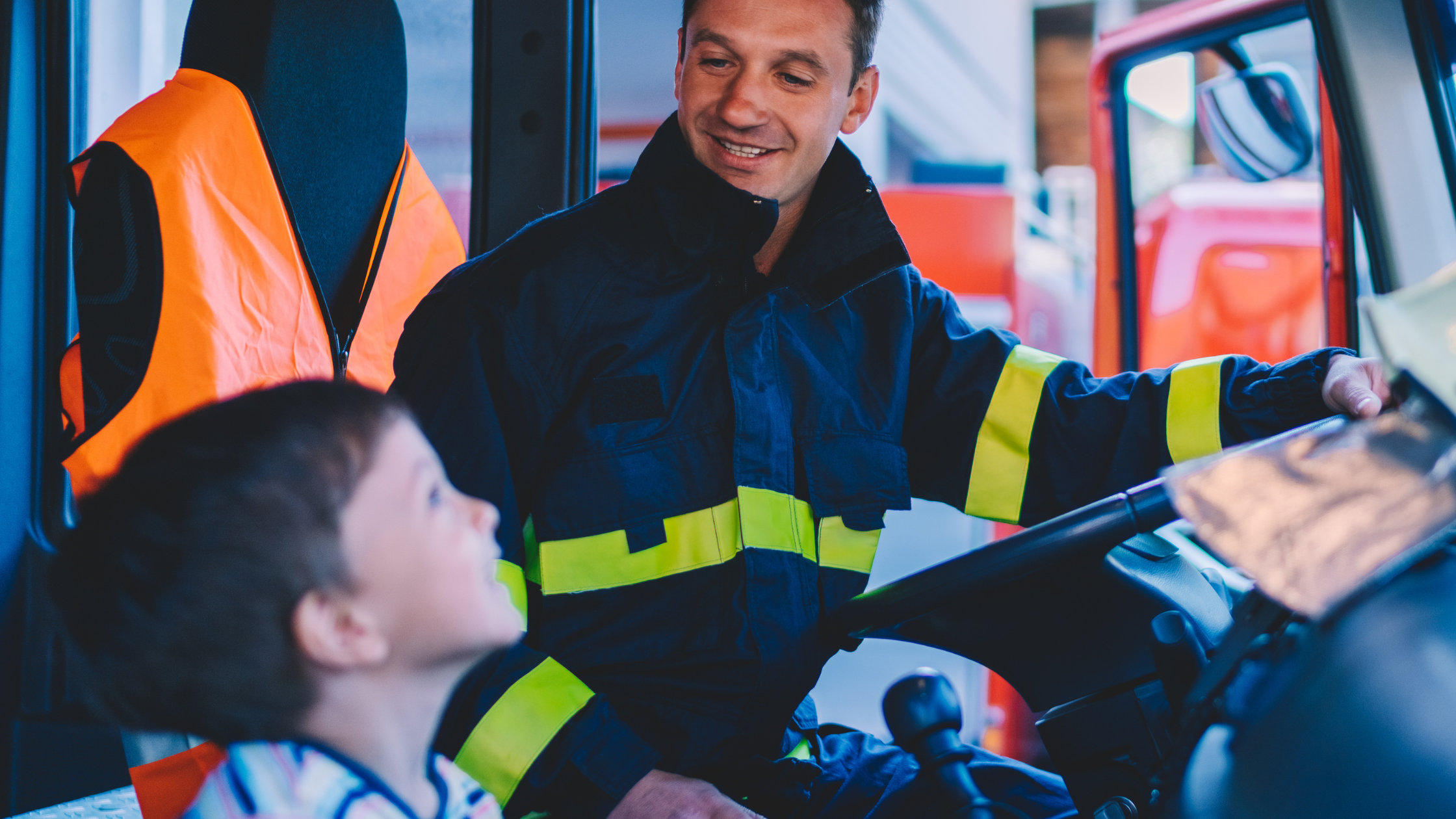 Firefighter in a truck with their child